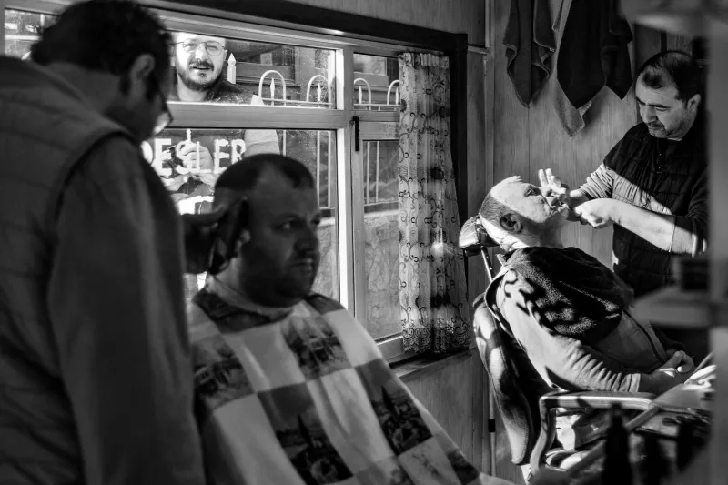 Two Dollars, No Appointment, Same Chair for Thirty Years: The Barbershop Democracy That Built America